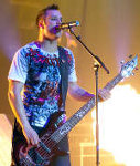 John Cooper of the band Skillet; shot at the Minneapolis Convention Center on November 14, 2009 during the 'Awake and Alive' concert tour playing in front of some pyro.